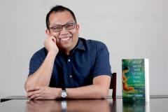 Author-leaning-on-table